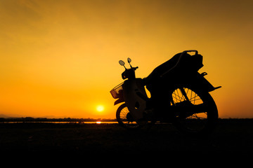 Fototapeta na wymiar Beautiful landscape image with vintage Motorcycle at sunset