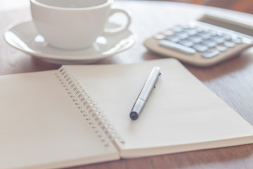 Blank notebook with pen on wooden table