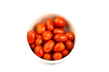 Fresh tomatoes in the bowl on white background