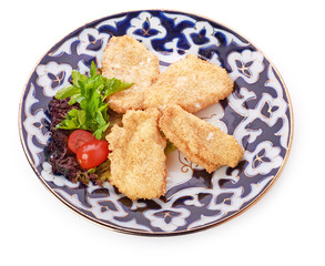 pile of chicken nuggets on white plate with sauce