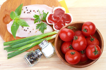 Raw chicken breasts on cutting board