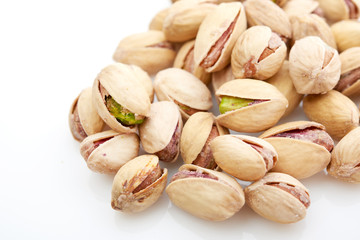 Heap of pistachios nuts isolated on the white