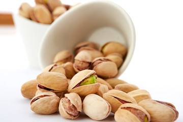 Heap of pistachios nuts isolated on the white