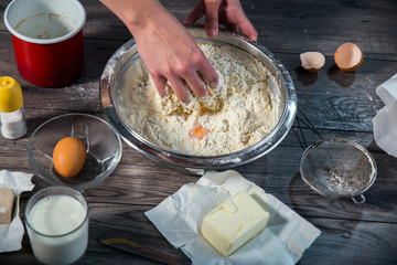 Cooking and home concept - close up of female hands kneading dou