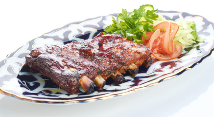 Meat on a grill with vegetables