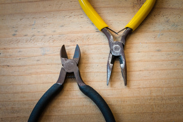 Old pliers and wirecutters on the wood