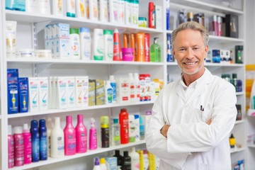 Senior pharmacist smiling at camera