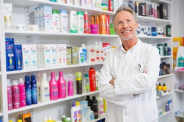 Senior pharmacist smiling and looking up