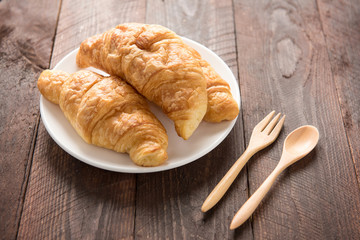 Fresh baked croissants on wood table