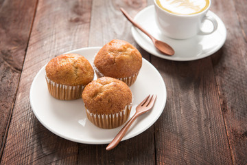muffin and coffee on wooden table