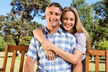 Couple relaxing in the park on bench