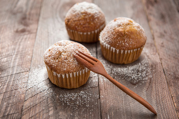 muffins and fork on a wooden table