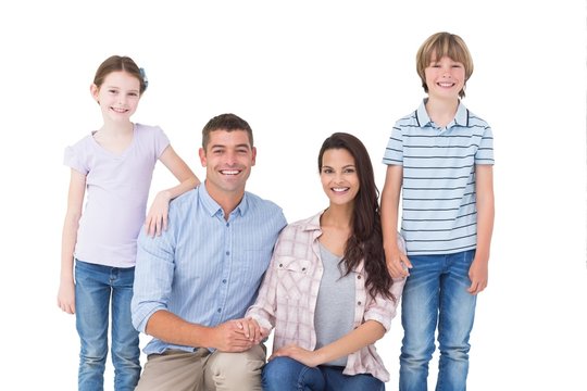 Family smiling together over white background