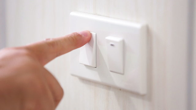 Close up clips of Man's had turning light on and off