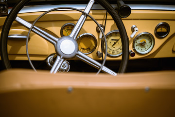 Steering wheel with dashboard and in retro car interior