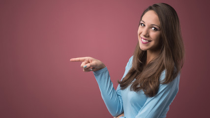 Smiling woman pointing left