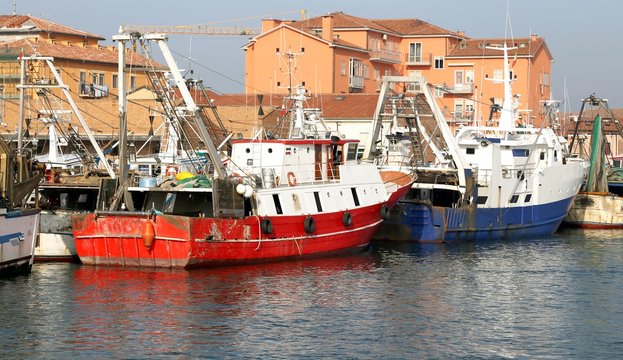 red fishing vessel moored in the harbor of the Mediterranean Sea