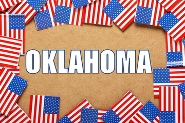 Fototapeta na wymiar The title Oklahoma with a border of USA flags