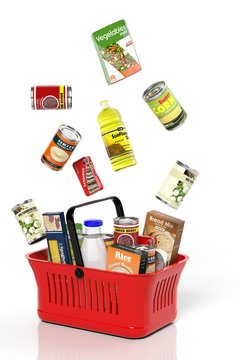 Full shopping basket with products isolated on white