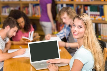 College students doing homework in library