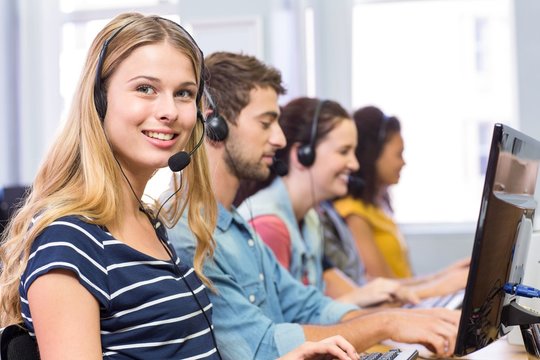 Students using headsets in computer class