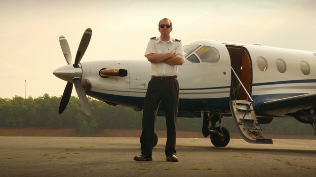 Proud Corporate Pilot Portrait with Jet Airplane Medium Shot