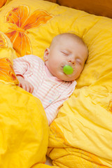 sleeping baby girl in big bed