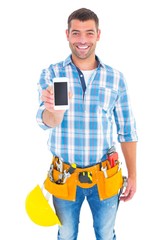 Portrait of smiling handyman showing mobile phone