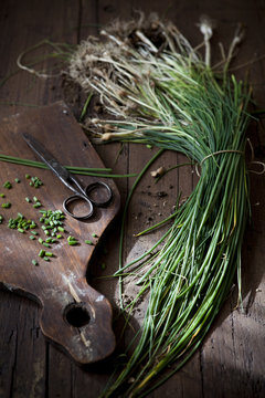 Bunch Of Wild Chives With Roots On Wooden Table