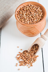 buckwheat in a wooden bowl on white background