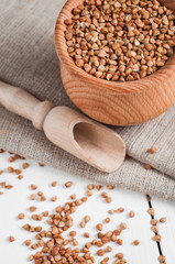 buckwheat in a wooden bowl on white background
