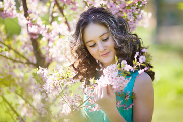 Fototapeta premium Beautiful young girl in flowers