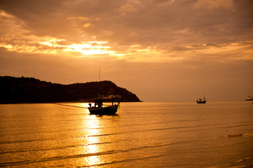 Fototapeta na wymiar sunset at sea and fishing boat