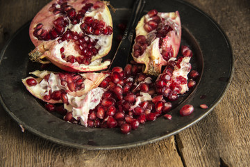 Moody natrual lighting images of fresh juicy pomegranate with vi