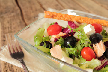 Healthy vegetable salad with fresh lettuce, olives and tomatoes