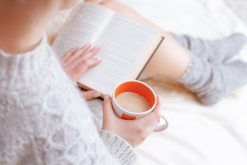 Soft photo of woman on the bed with old book  in hands