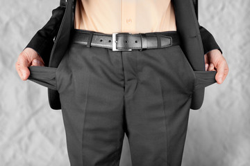 bankrupt  man showing empty pockets