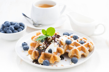 waffles with fresh blueberries, cream and chocolate sauce