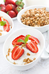 whipped cream with fresh strawberries and granola, vertical