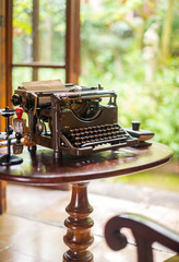 Antique typewriter on table by the window.