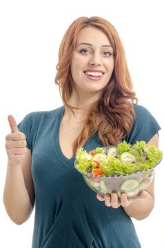 Happy woman eating salad. Woman keeping a diet with green salad