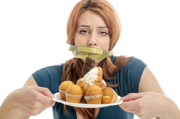 Woman with a centimeter on her mouth unable to eat the sweets