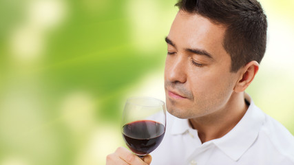 happy man drinking red wine from glass