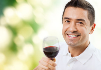 happy man drinking red wine from glass