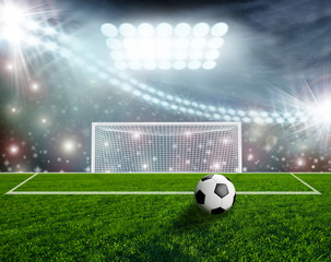 Fototapeta premium Soccer ball on green stadium arena