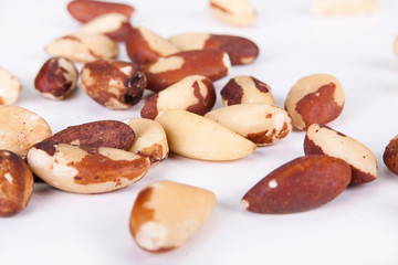 Five big, beautiful, Brazilian walnut on a white background.