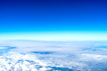 Fototapeta na wymiar Cloudy blue sky from aircraft view
