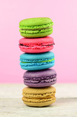 colourful stack flavoured macaron on white wood background