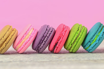 colourful stack flavoured macaron on white wood background