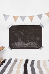 Blackboard with children's drawings in a playroom